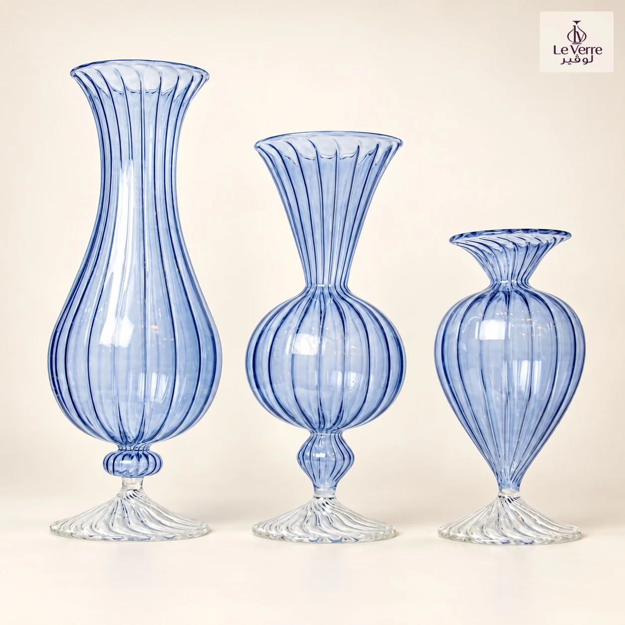 Three blue-striped glass vases of different heights with fluted rims and twisted clear feet, AI-assisted studio presentation
