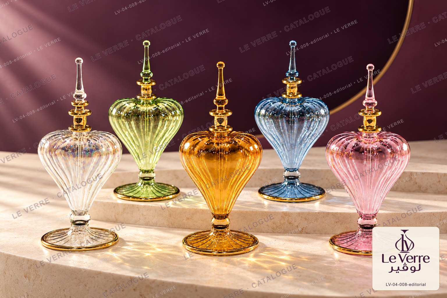 Le Verre catalogue image: five fuller ribbed glass perfume bottles in clear, green, amber, blue and pink with spire stoppers, with the Le Verre catalogue logo